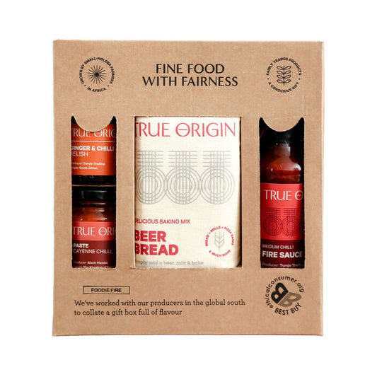 Gift set packaging with True Origin products including a baking mix and sauces.